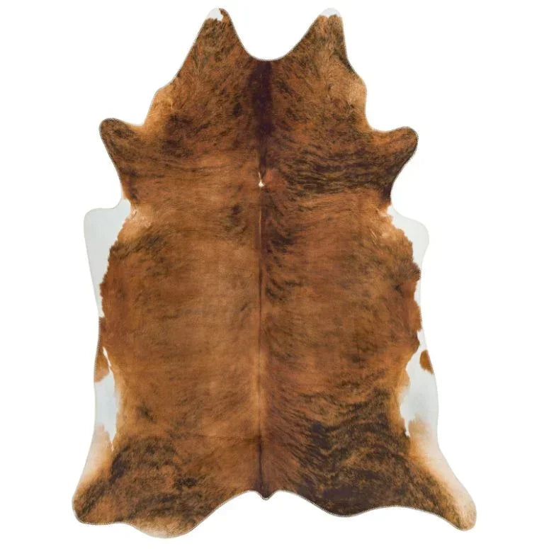 Brown and white cowhide rug with natural patterning on white background