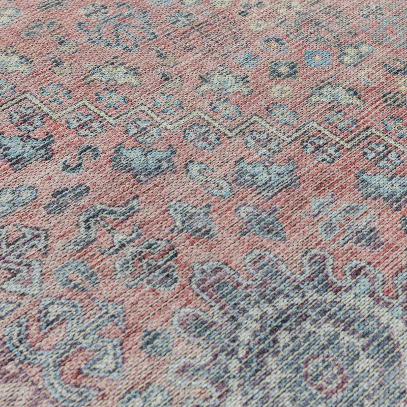 Close-up of pink and blue patterned rug with textured woven material