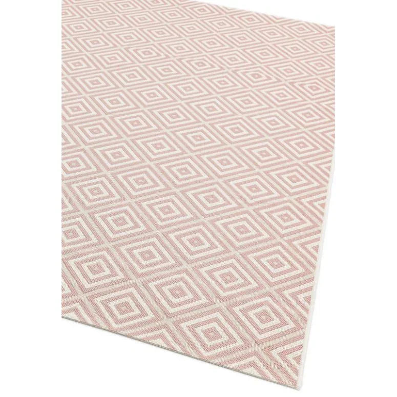 Pink geometric patterned area rug with diamond shapes on white background