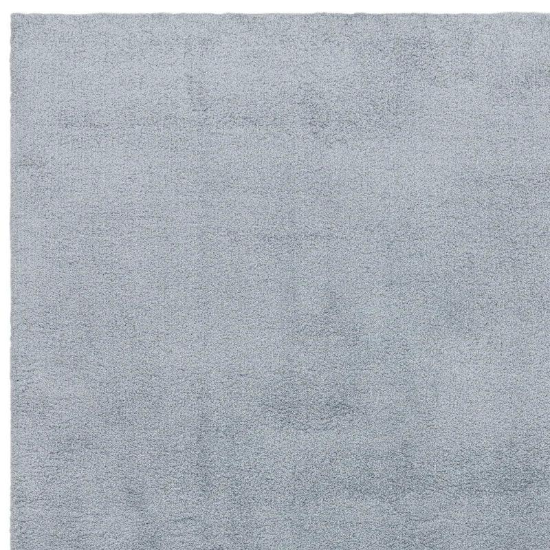 Light grey shaggy rug with soft textured pile, shown from above