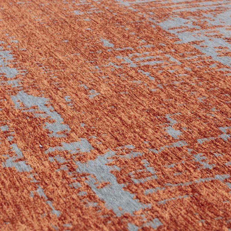 Close detail of orange and grey area rug with textured pile