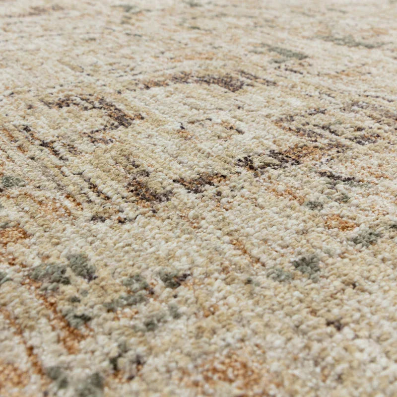 Beige patterned rug with textured pile and subtle green and brown details, close-up view
