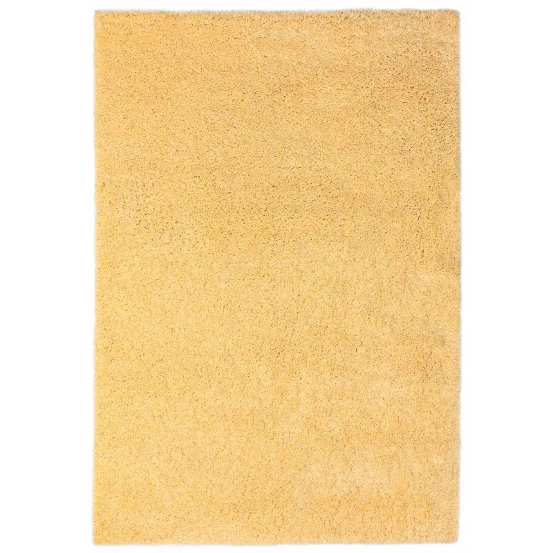 Rectangular yellow shaggy rug with soft texture on white background