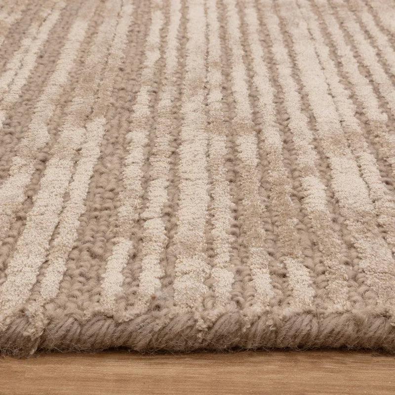 Beige textured wool rug with striped pattern on wooden floor