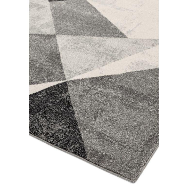 Grey geometric rug with triangles in light and dark shades, close angle of corner view