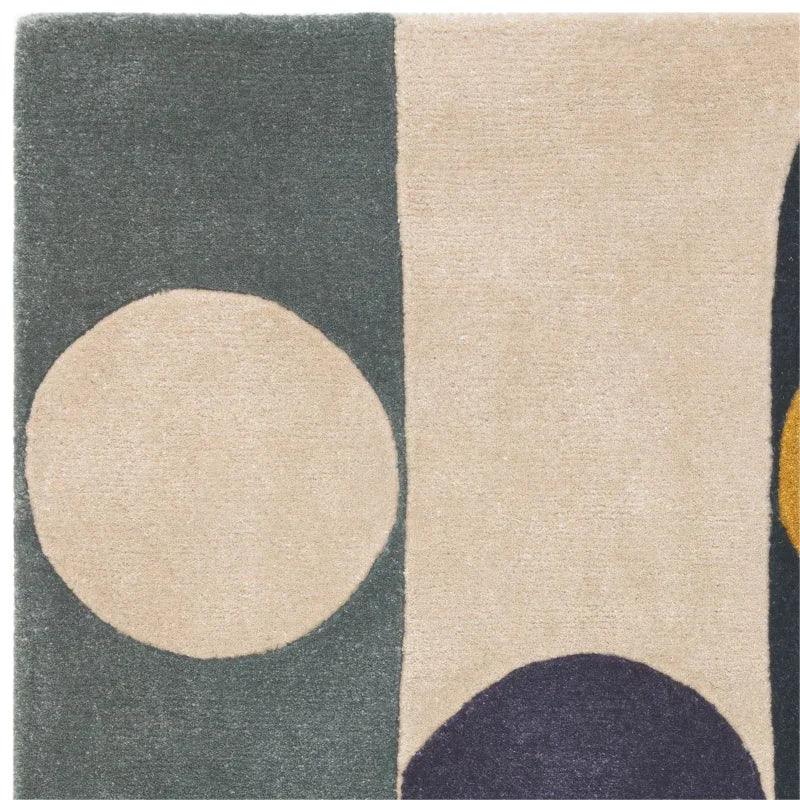 Modern abstract rug with cream, green, yellow and navy geometric shapes
