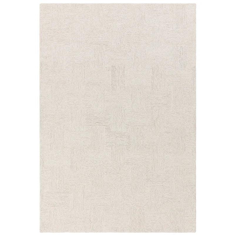 Beige textured area rug with subtle geometric pattern, photographed from above