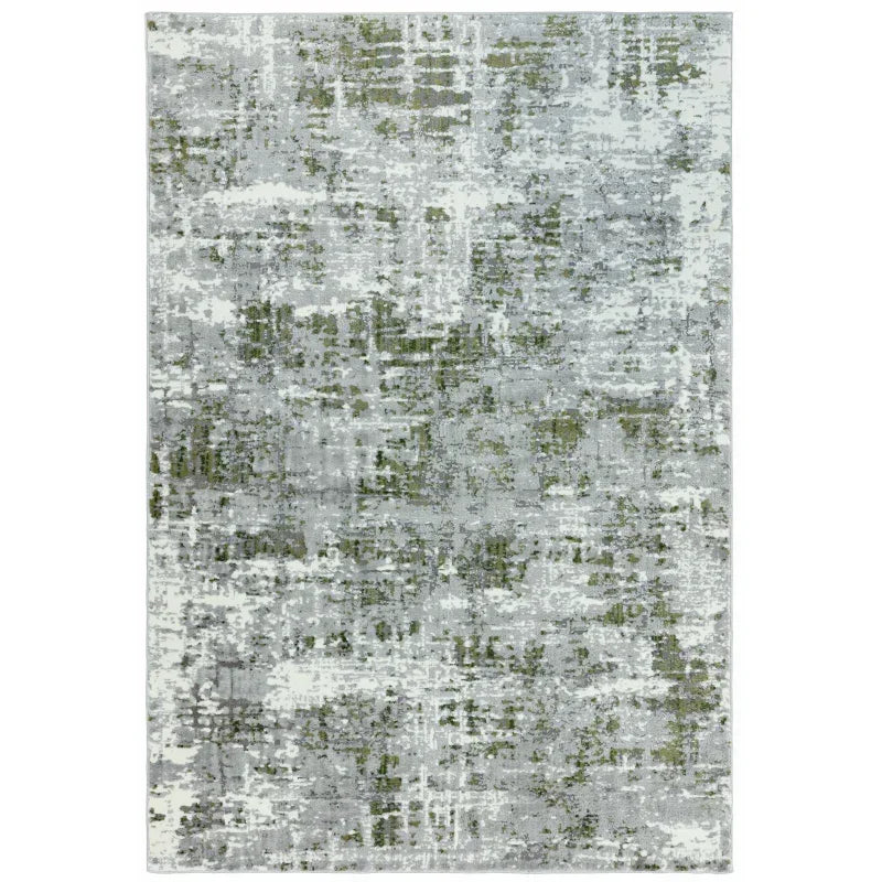 Abstract grey and green area rug with modern distressed pattern