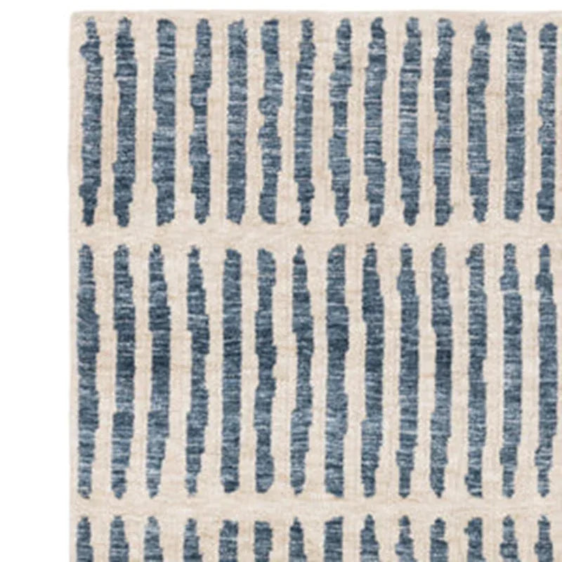 Beige and blue patterned rug with vertical stripe design, close-up view