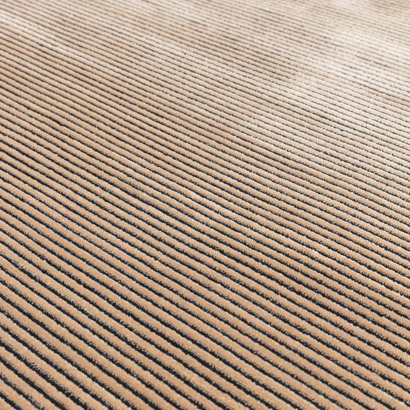 Beige corduroy fabric upholstery with vertical ribbed texture close up