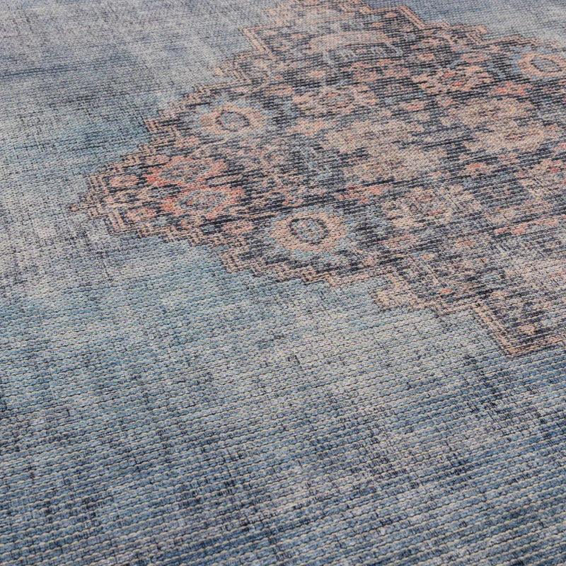 Blue patterned area rug with subtle geometric and floral design detail