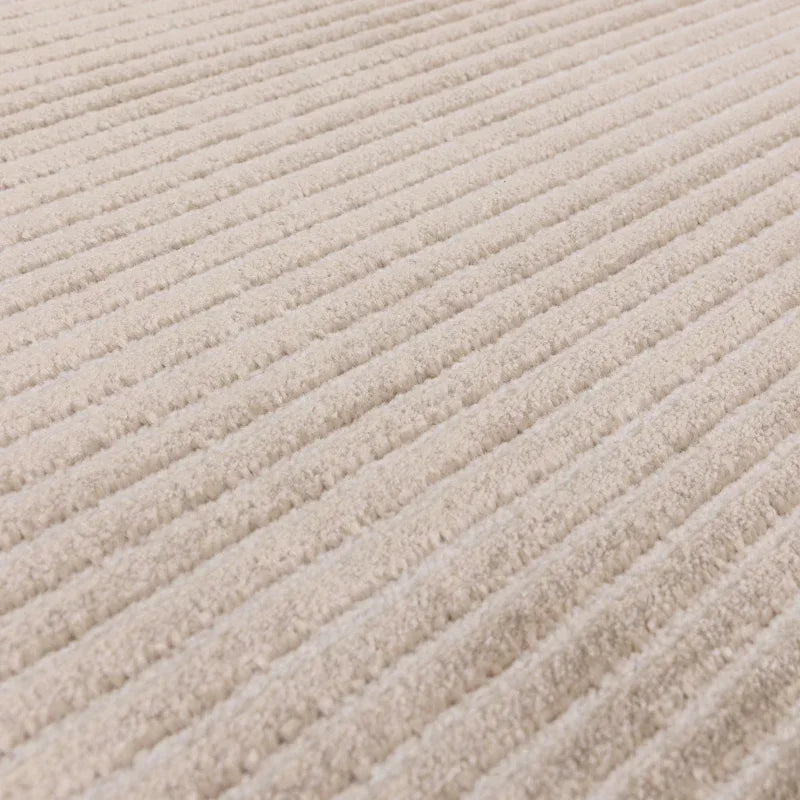 Beige corduroy fabric upholstery with ribbed texture for sofa or furniture closeup