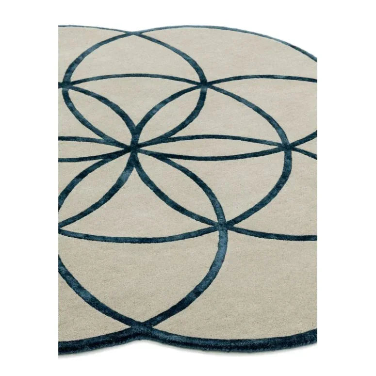 modern area rug with overlapping navy blue circular pattern on beige background