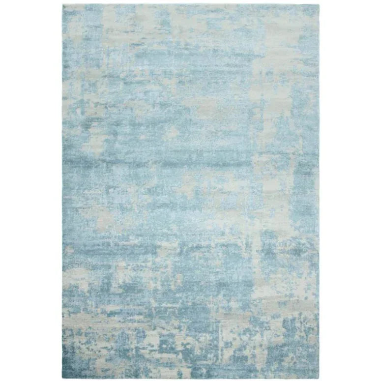 Abstract blue and cream area rug with textured pattern and soft finish