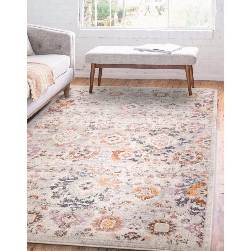 Patterned area rug with muted orange, grey and lavender tones in modern living room