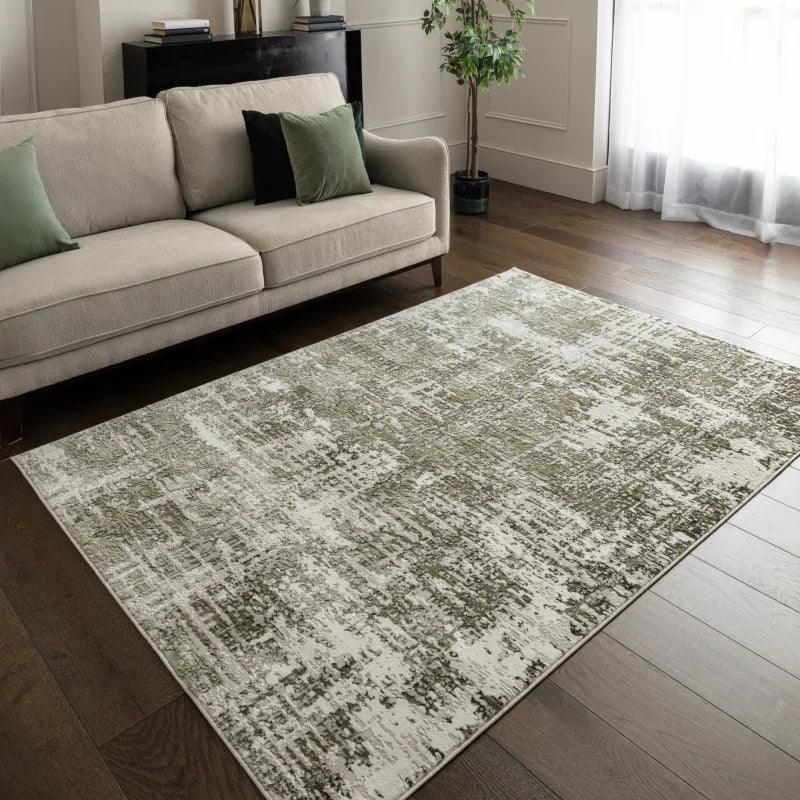 Modern abstract area rug in cream and green tones on living room wooden floor