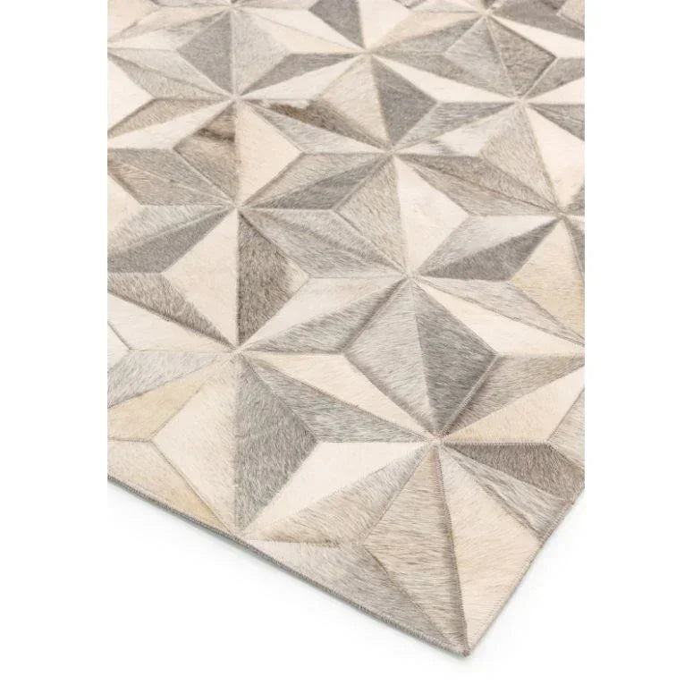 Geometric patterned area rug in neutral tones with textured diamond shapes