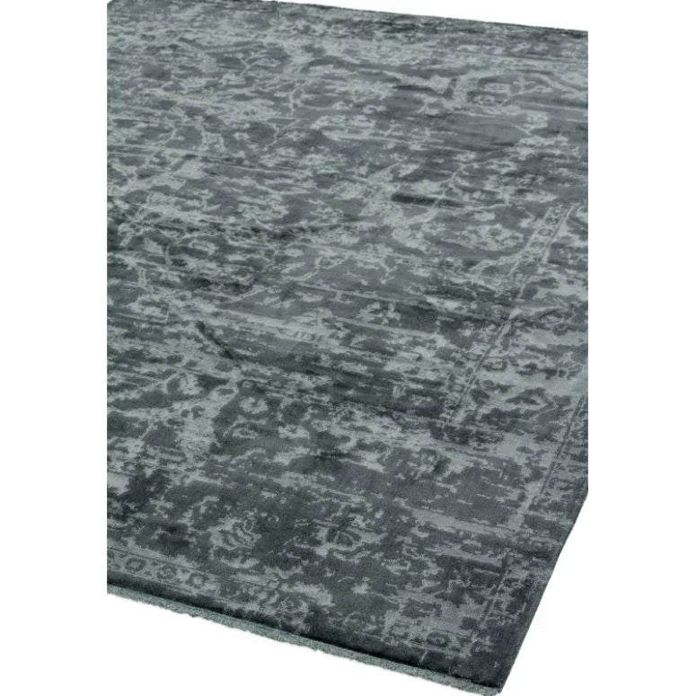 Grey patterned area rug with subtle distressed design and soft texture, corner view
