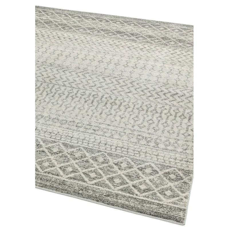Grey patterned area rug with geometric design and textured surface