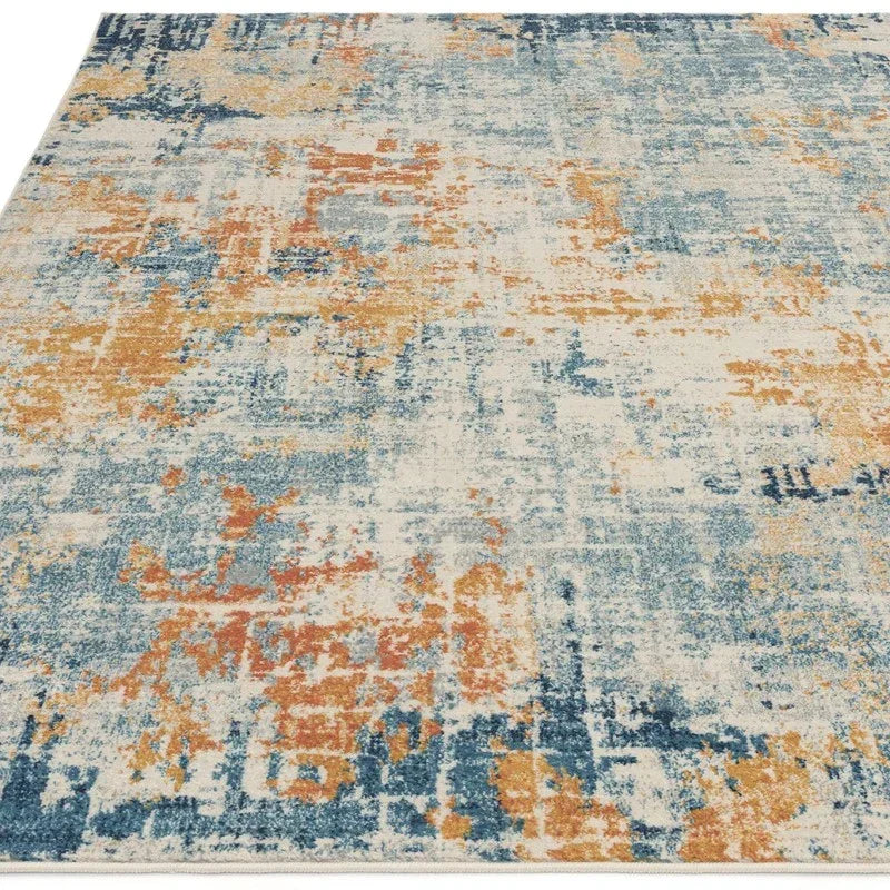 Modern area rug with abstract blue and orange pattern, low pile, angled front view