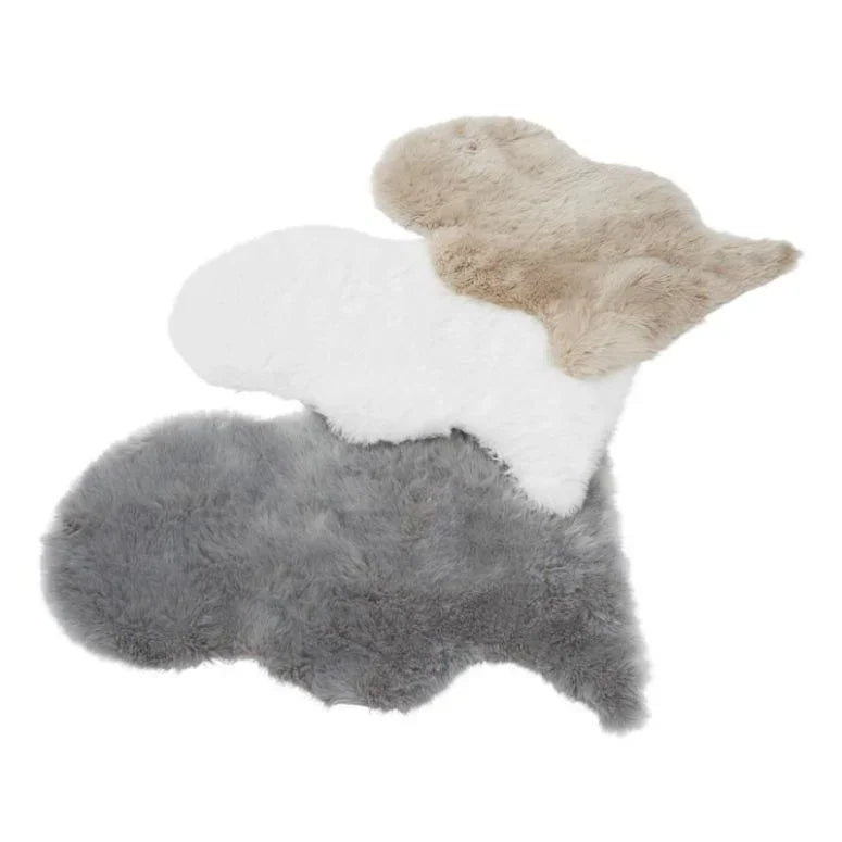 Sheepskin rug trio in beige, white, and grey on white background