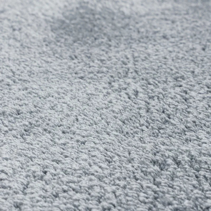 Light grey textured carpet close-up showing soft, plush pile and fibre detail