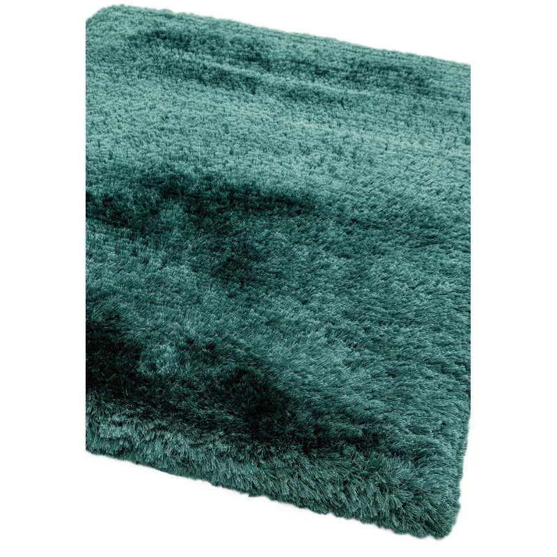 Closeup of green shaggy rug with thick pile texture