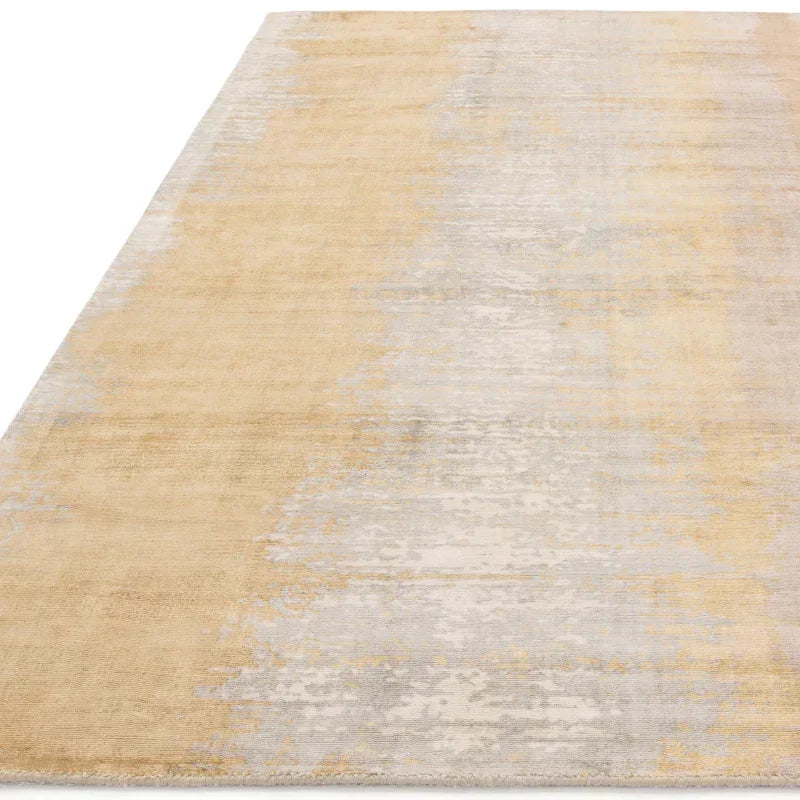 Beige and grey area rug with subtle gradient pattern, close view of surface texture