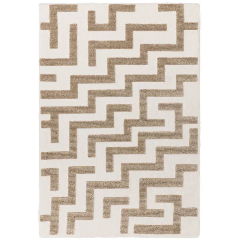 Beige geometric rug with raised textured pattern on white background