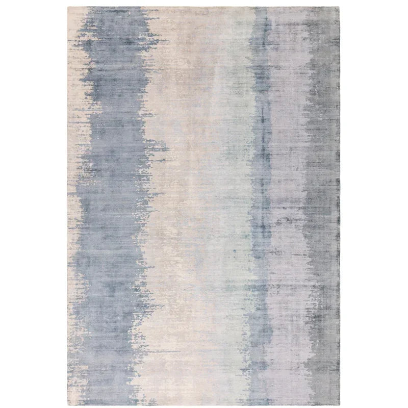 Modern area rug with blue and grey abstract pattern on a light background, rectangular shape