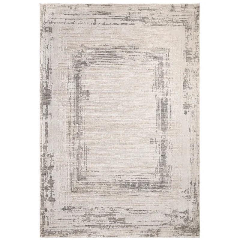 Beige and grey area rug with modern geometric border pattern