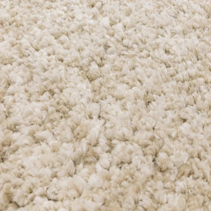 Close-up of cream shaggy rug with soft, textured pile