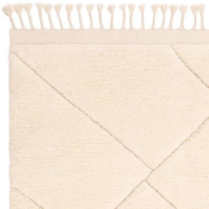 Cream textured rug with diamond pattern and tassel edge detail