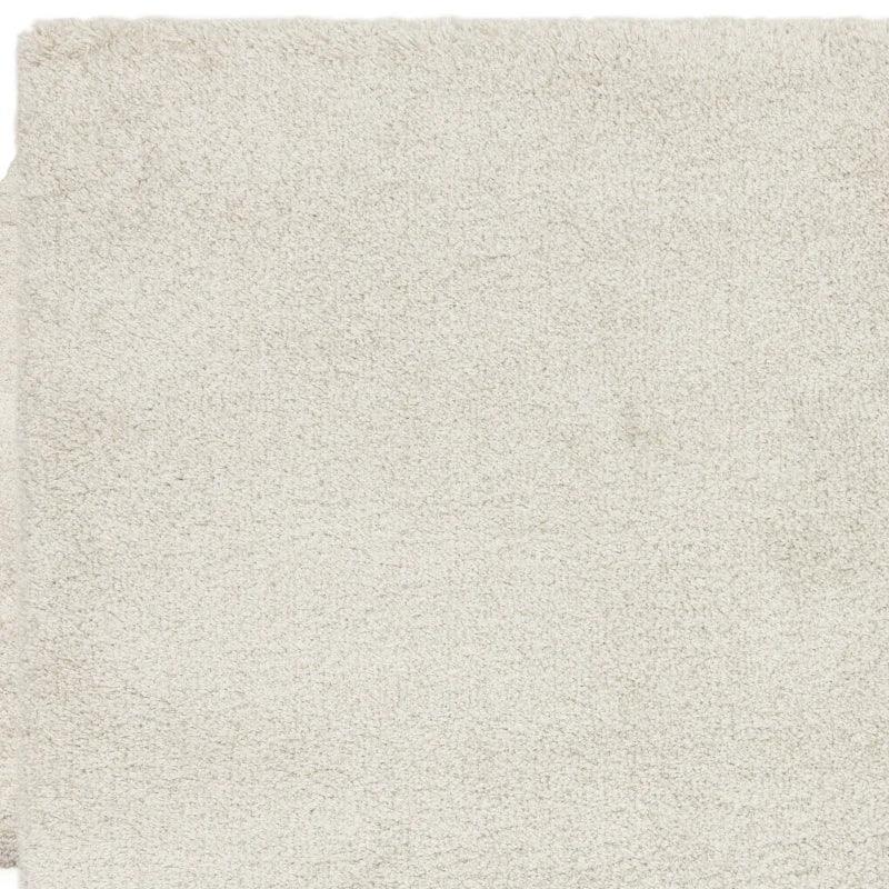 close view of cream shaggy rug texture and pile