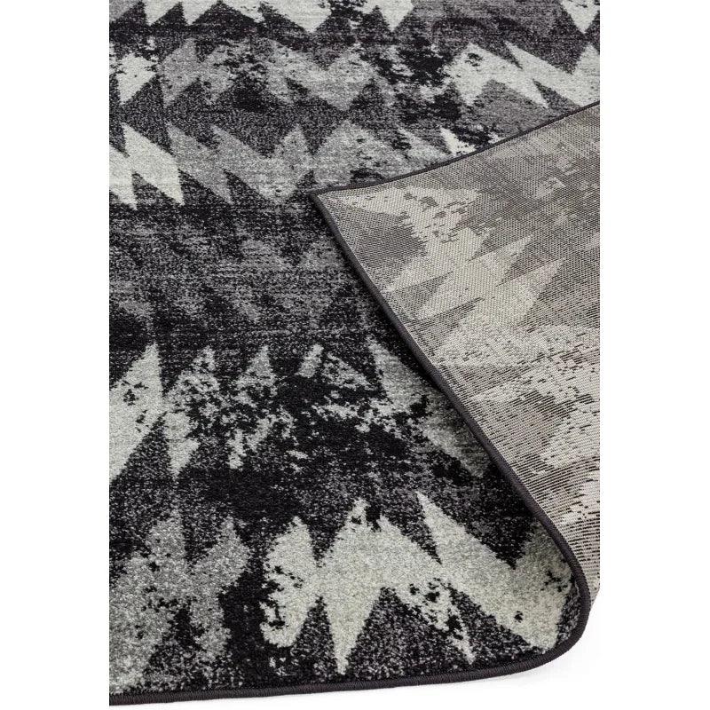 Monochrome patterned area rug with zigzag design and corner detail, modern home decor