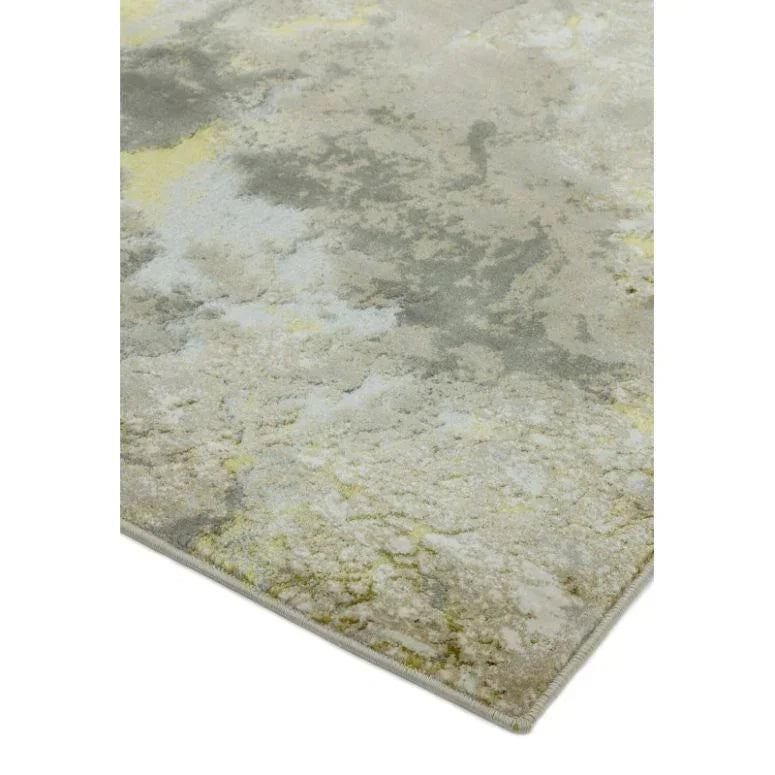 Abstract area rug with soft grey, cream, and yellow pattern, close corner angle view