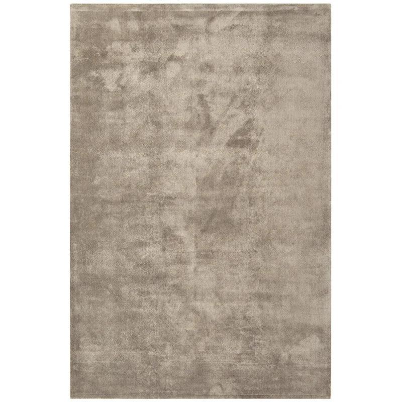 Large rectangular beige rug with a soft, plush texture and subtle tonal shading
