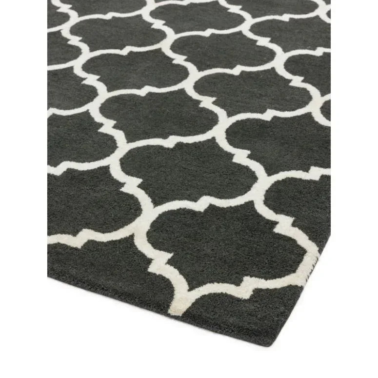 Black and white patterned area rug with geometric lattice design, close corner view