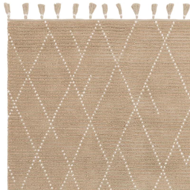 Beige woven rug with diamond pattern and tassel edging detail