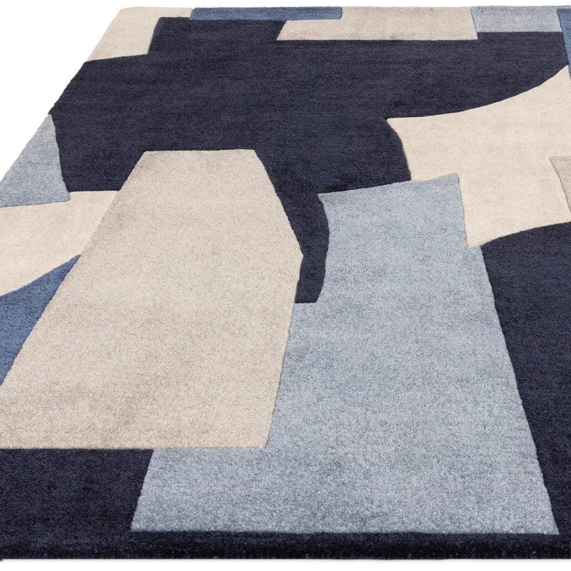 Modern area rug with geometric pattern in navy, grey, and cream tones