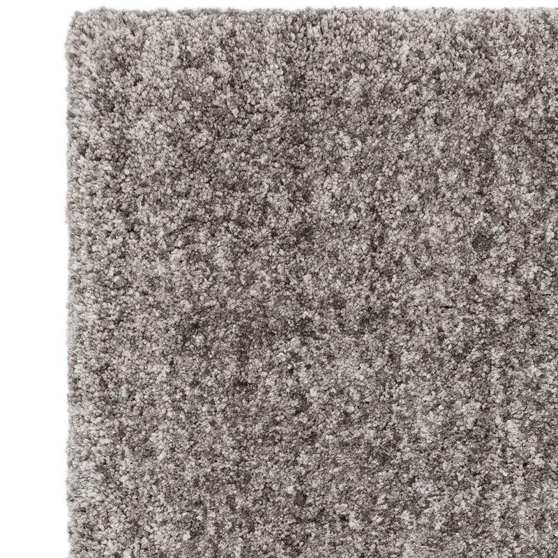 Close-up of grey shaggy rug texture with thick, soft pile
