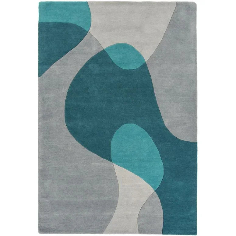 Modern area rug with abstract teal, grey, and light blue shapes on a rectangular design