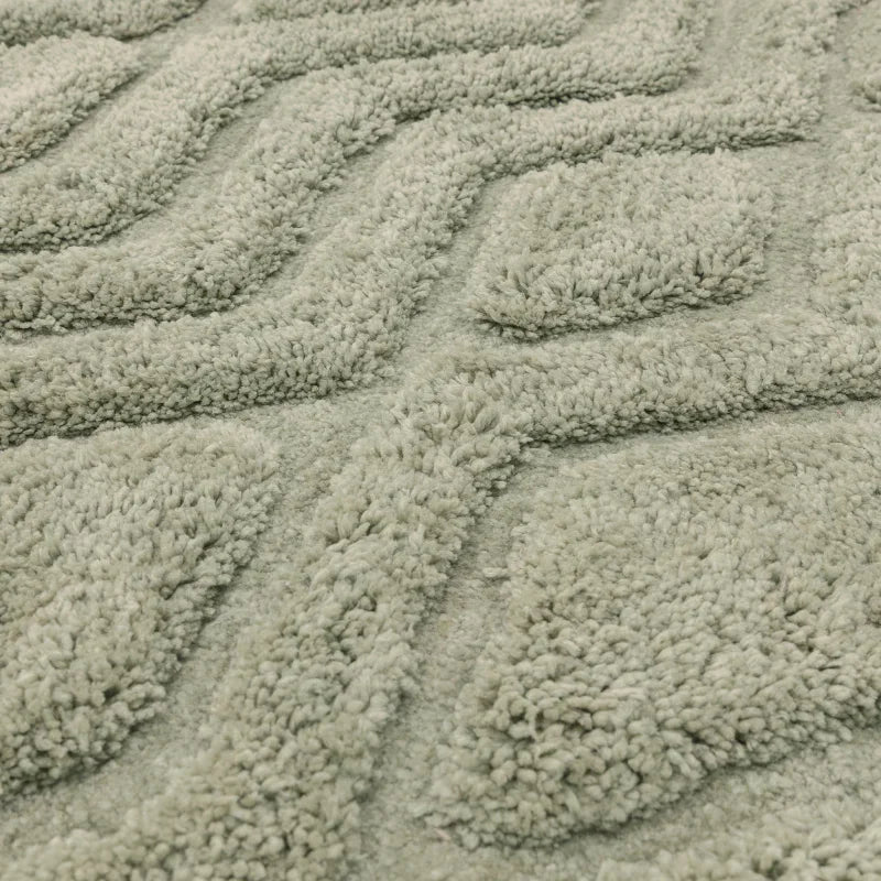 Close-up of textured light green rug with raised geometric pattern