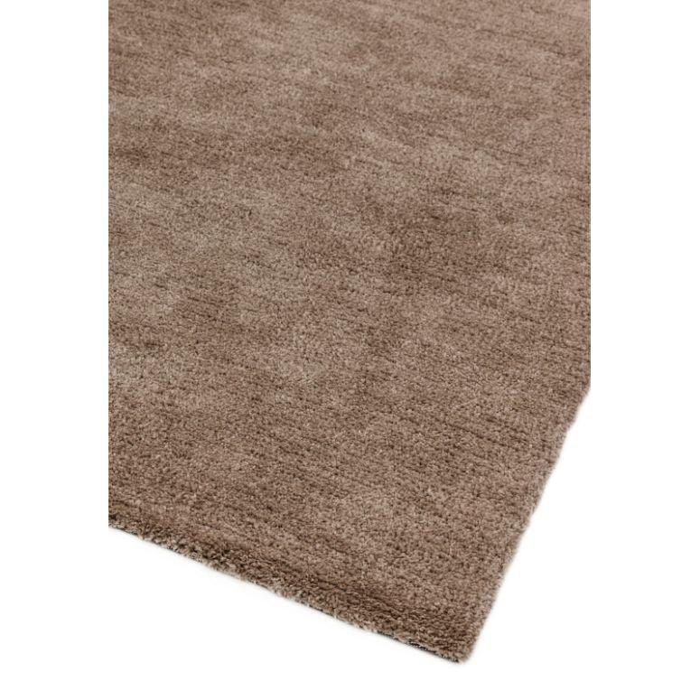 Brown textured area rug with soft pile shown from a corner angle