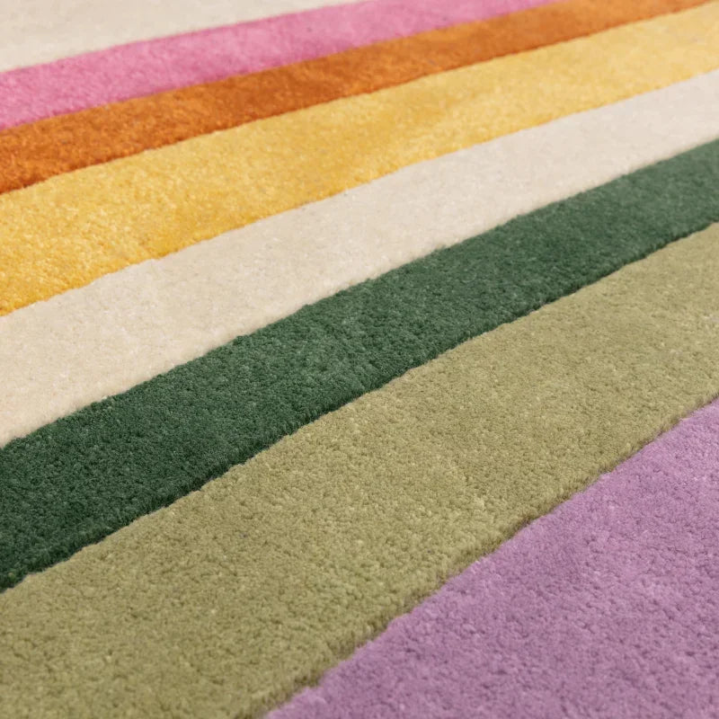 Multicolour striped rug with pink, orange, yellow, green and cream bands, close-up view