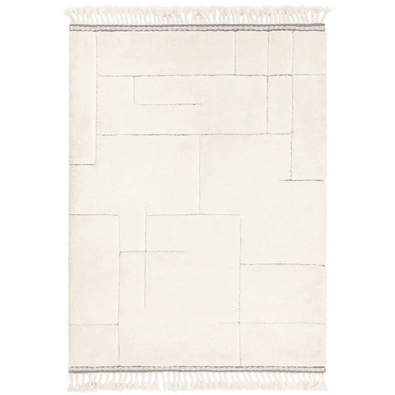 Cream geometric area rug with subtle line pattern and fringed edges