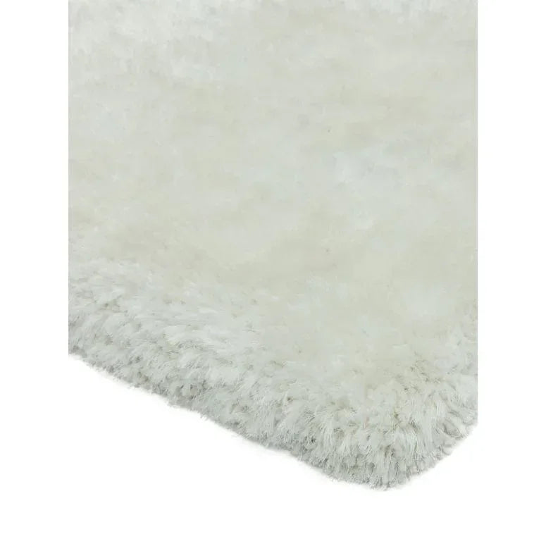 Close-up of white fluffy area rug with soft textured pile