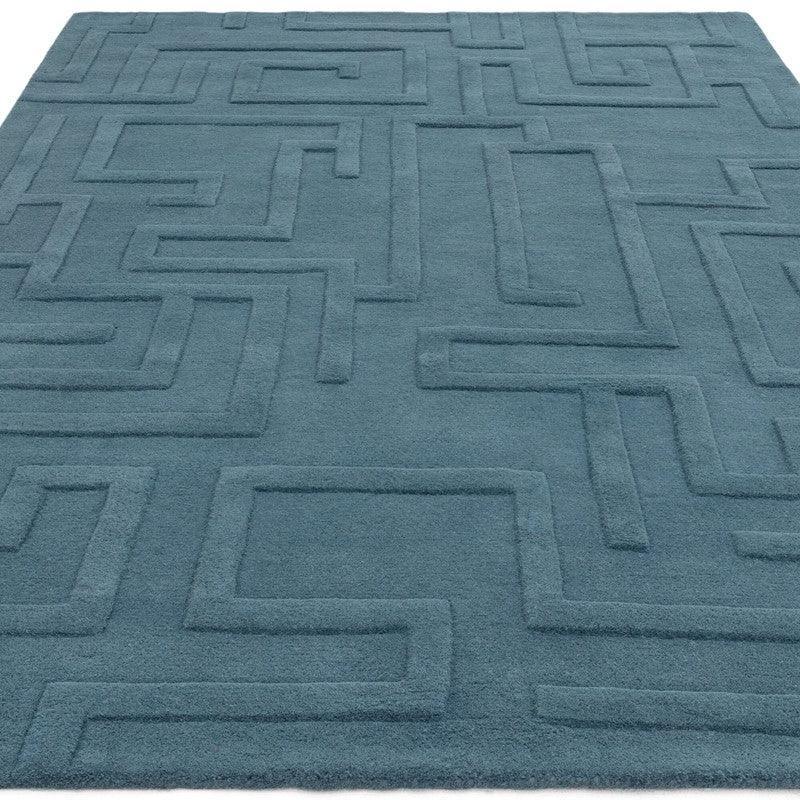 Blue geometric pattern rug with raised textured lines and soft surface