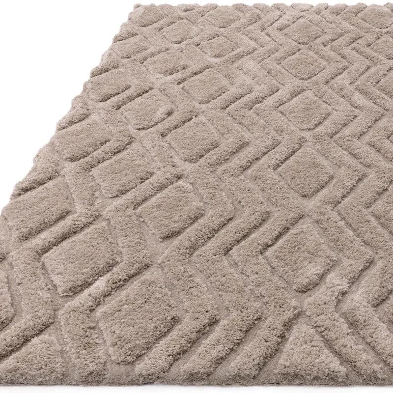 Beige textured rug with raised diamond pattern, close-up of soft pile and geometric design