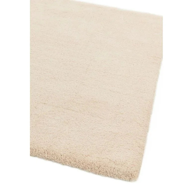 cream shaggy rug corner close-up with thick pile texture